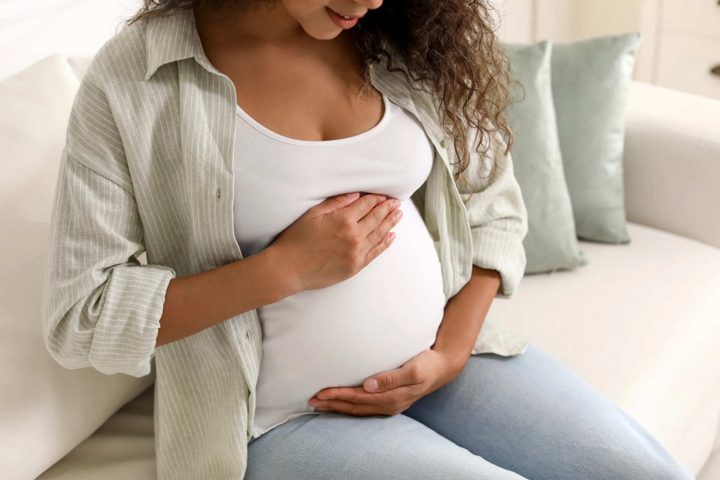 Pregnant woman receiving gentle prenatal chiropractic care Pregnant woman receiving gentle prenatal chiropractic care